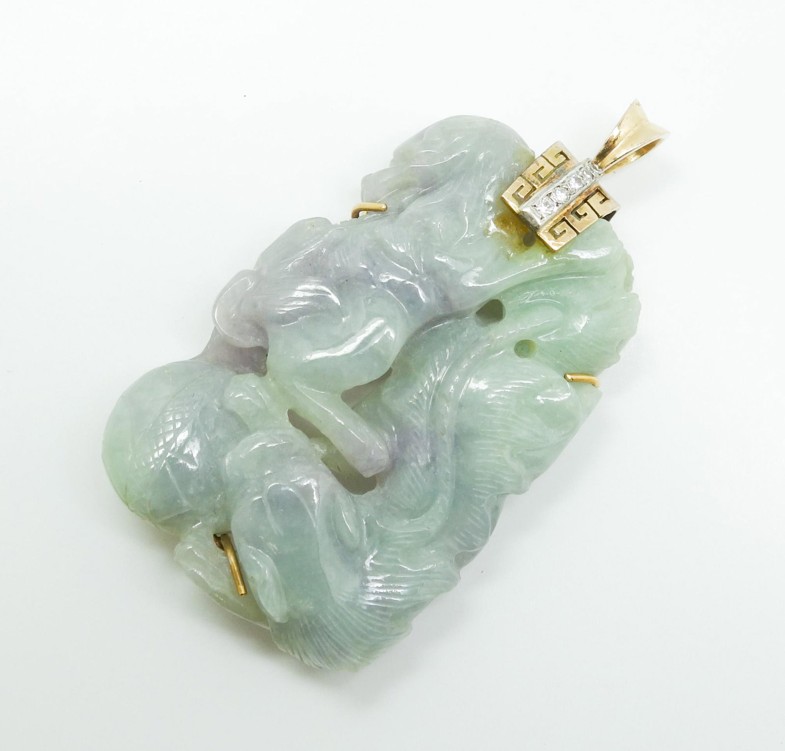 Mason Kaye Certified Green Lavender Jadeite 14k Pendant: This is a vintage jadeite pendant. Rendered in fine 14k white and yellow gold, it features a curved dragon holding a ball. There are 5 full cut diamonds set in a white gold strip and bordered by a yel