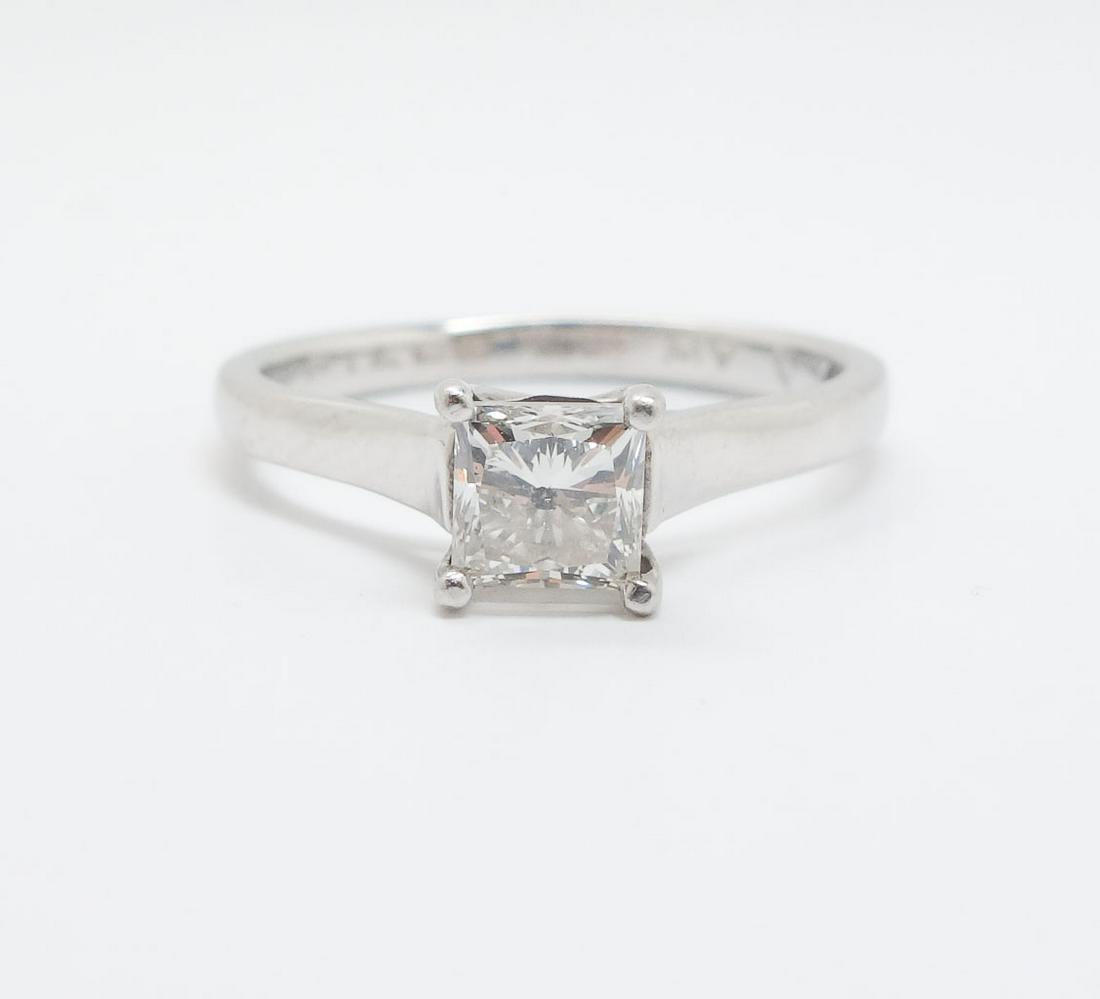 Platinum Princess Cut Diamond 1ct Solitaire Ring Size 8: This is a platinum Princess cut diamond solitaire engagement ring. The interior of the band is inscribed "Piece of my heart (symbol)". The diamond clarity is I1-2 and the color is J-K. Ring size 8 US.
