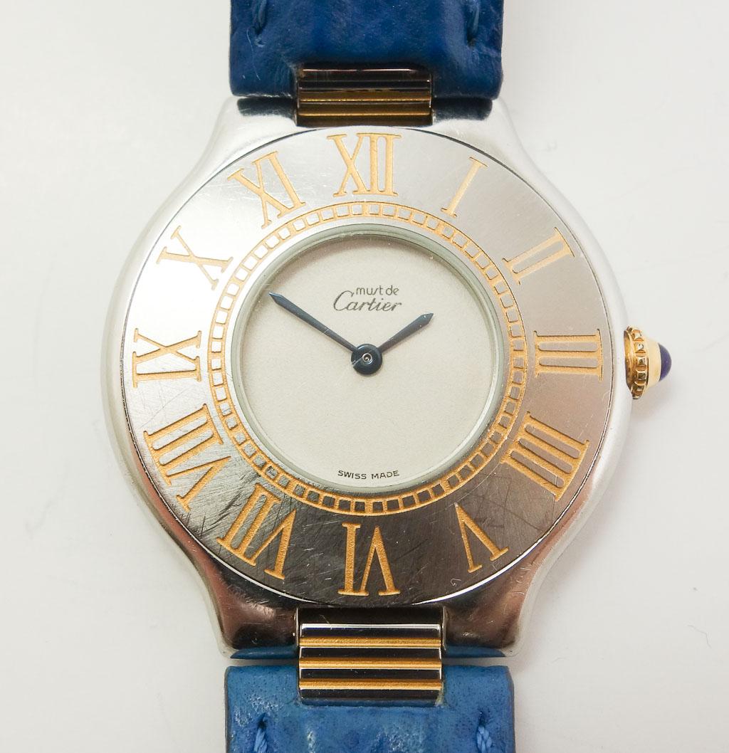 Must de Cartier 21 Watch (model): This is a fine Cartier woman's watch. It features a quartz 9-jewel movement. This watch comes with its original leather Cartier strap. The inside of the case is marked "11-94t SO4" in permanent ink. T