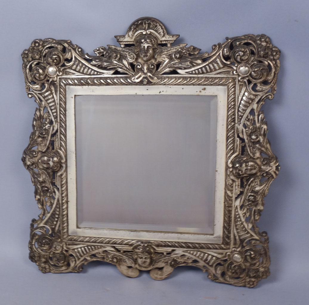 Antique B&H Silvered Winged Cherub Head Table Mirror: This is a charming and exceptional antique cast iron mirror from Bradley & Hubbard dating to the19th century. The ornate silvered mirror features winged cherubs along each side. Nice beveled edges to 