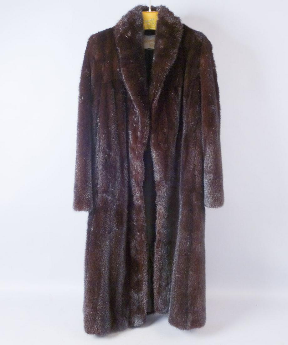 Full Length M Solomon Mink Fur Coat Rarely Worn: Full length dark mink coat with an M Solomon label. Elaborate stitching on the lining near the hem. Initials "VRB" are stitched in the lining of the front right side. Features a large black button und