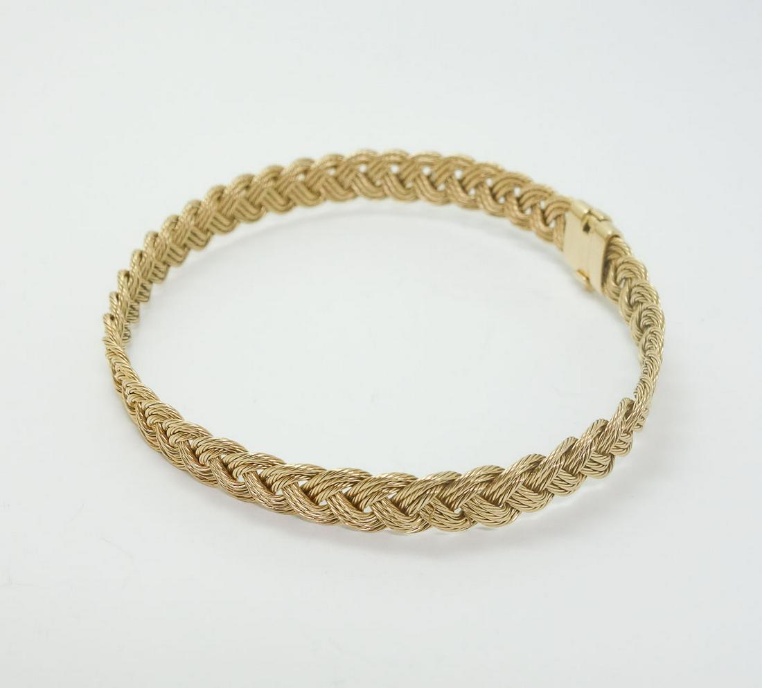 Guy Beard Designs Nautical Weave 14k Gold Bracelet: This is a vintage Guy Beard woven bracelet. Rendered in fine 14k yellow gold, it features a 3 plait braid with each plait made up of 3 twisted gold wires. The inside of the clasp is stamped "TMI" and 