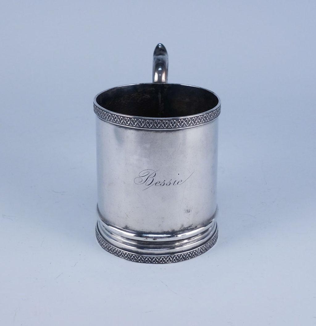 American Coin Silver Mug "Bessie" John Westervelt NY: This is a charming estate found mug crafted by John L Westervelt of Newburgh, New York (active 1826-1850). Rendered in fine American Coin Silver, this mug features a Gothic Revival repeating heart mot