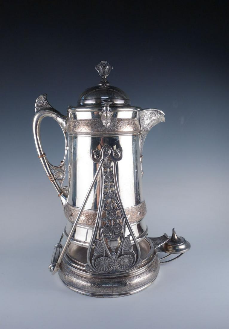 19C American Silverplated Renaissance Revival Pitcher: This is a beautiful estate found antique ice water pitcher dating to the Victorian era of the 19th century. From Reed and Barton, the silver plated pitcher on a stand is decorated in eye-catching Rena