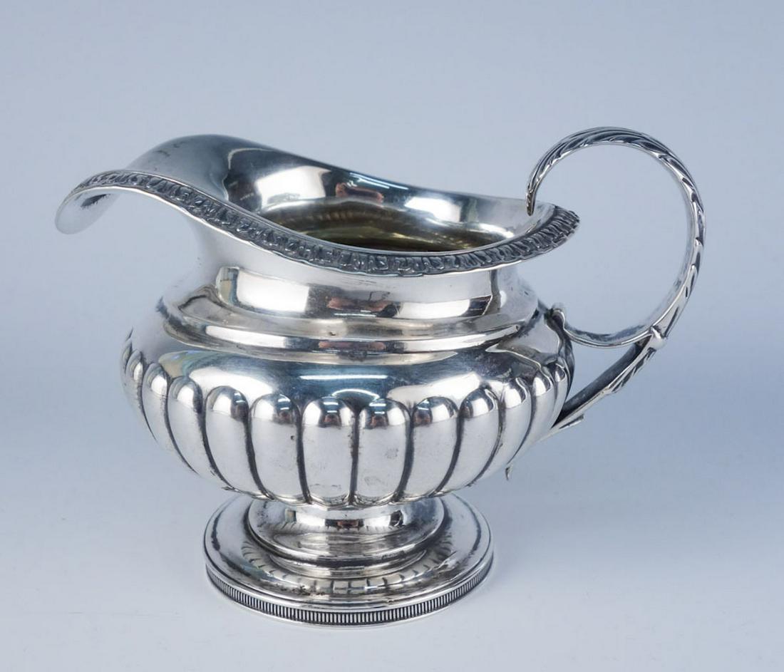 1819 Scotland McHattie Sterling Silver Ornate Creamer: This is a handsome estate found antique cream pitcher crafted by George McHattie of Edinburgh, Scotland in the early 19th century. Rendered in fine sterling silver, this pitcher features ornate detail