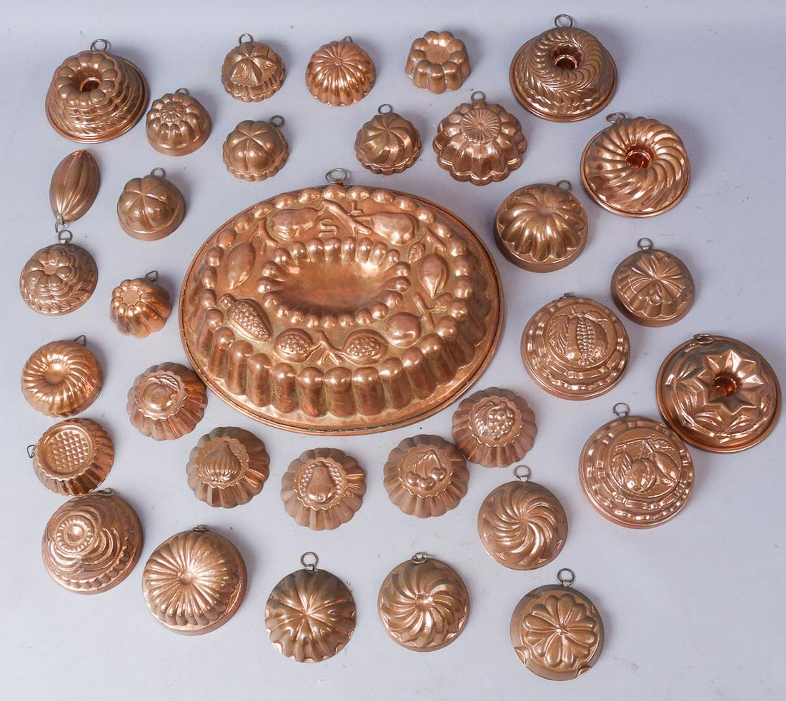 Group 32 Decorative Copper Food Molds incl. Birth-Gramm: Lot of 32 copper food molds with stickers marking items from Switzerland and Turkey. Molds range from 2 3/4" - 13 3/8" across. This lot weighs 6 1/4 lbs.