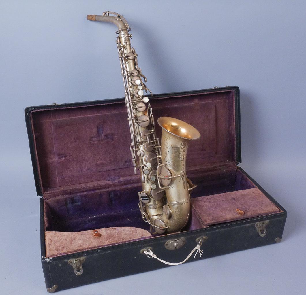 1925 Buescher True-Tone Low Pitch Alto Saxophone: Buescher brand saxophone with hard case. The saxophone is stamped "185675 True-Tone Trademark Registered Low Pitch License Pat. Dec. 8 1914". The front of the bell is etched "The Buescher Elkhart Ind.