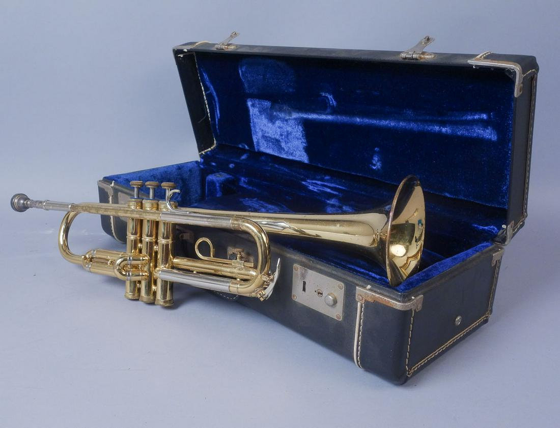 Vintage Cased York Trumpet: York brand trumpet with case. The center valve is stamped "703081". The bell is etched "York". The mouthpiece is stamped "York 7C." This lot weighs 8 lbs.