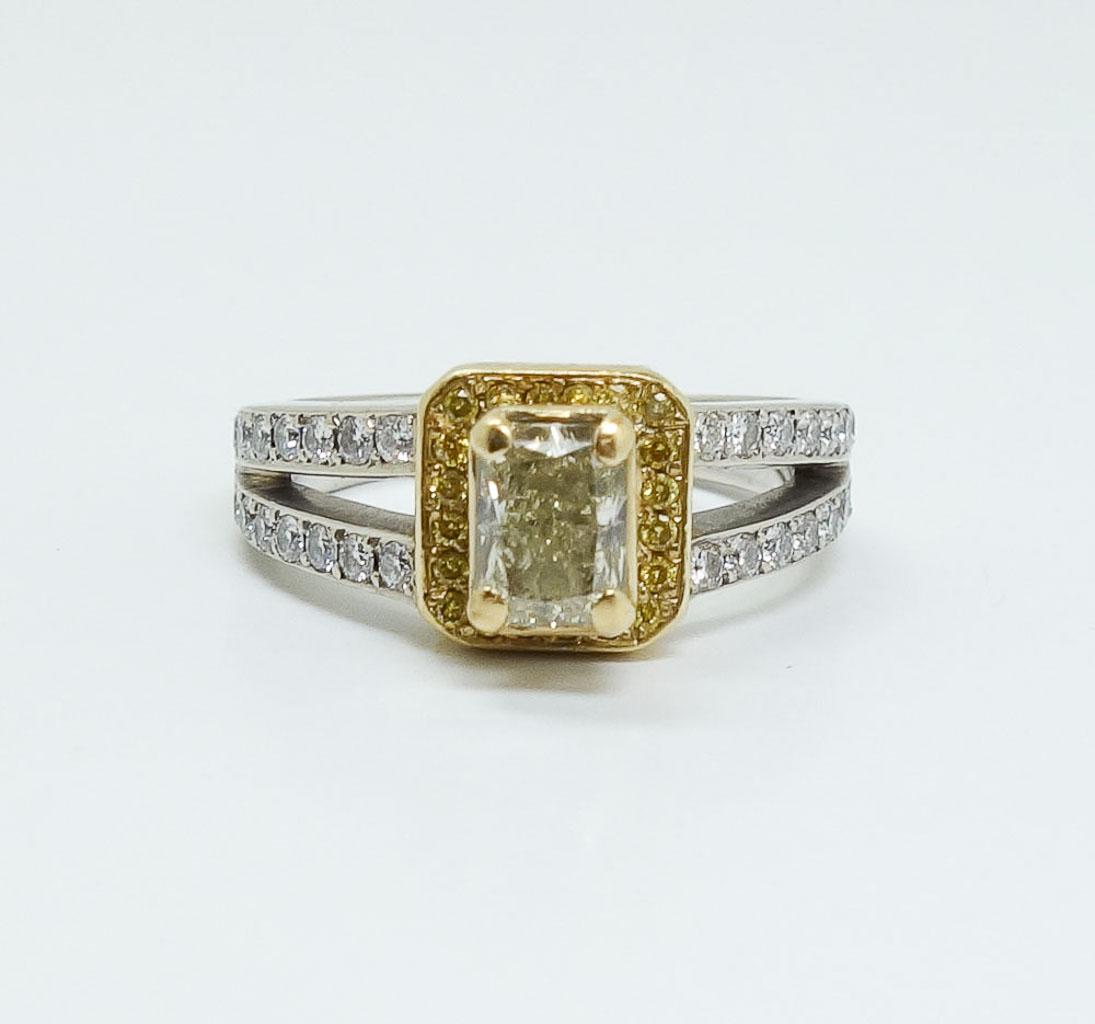 1tcw Fancy Yellow Diamond 14K White & Yellow Gold Ring: This is an elegant estate found engagement ring accompanied with the original purchase receipt and certificate. Rendered in fine white and yellow gold, this ring features a .70ct rectangular cut yello