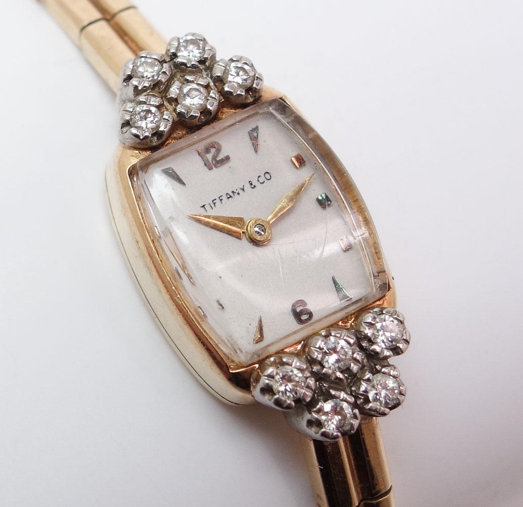 Art Deco 14k Gold Diamond Tiffany Movado Ladies Watch: This is an elegant estate found Art Deco ladies Movado wristwatch made for Tiffany & Co. Rendered in fine 14K gold, this watch features diamonds. This watch weighs 16.5g The watch case measures 17.1mm