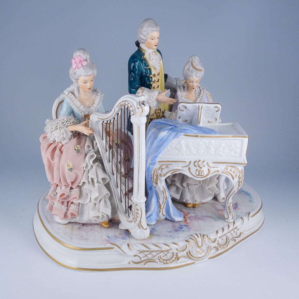 Hoffner W. German Crinoline Porcelain Harpsichord Harp: Charming group of figures playing music together on a harpsichord and lute. It was made in the mid 20th century by Hoffner & Co. in Sandizell, West Germany. Hoffner & Co. was a small family owned busi