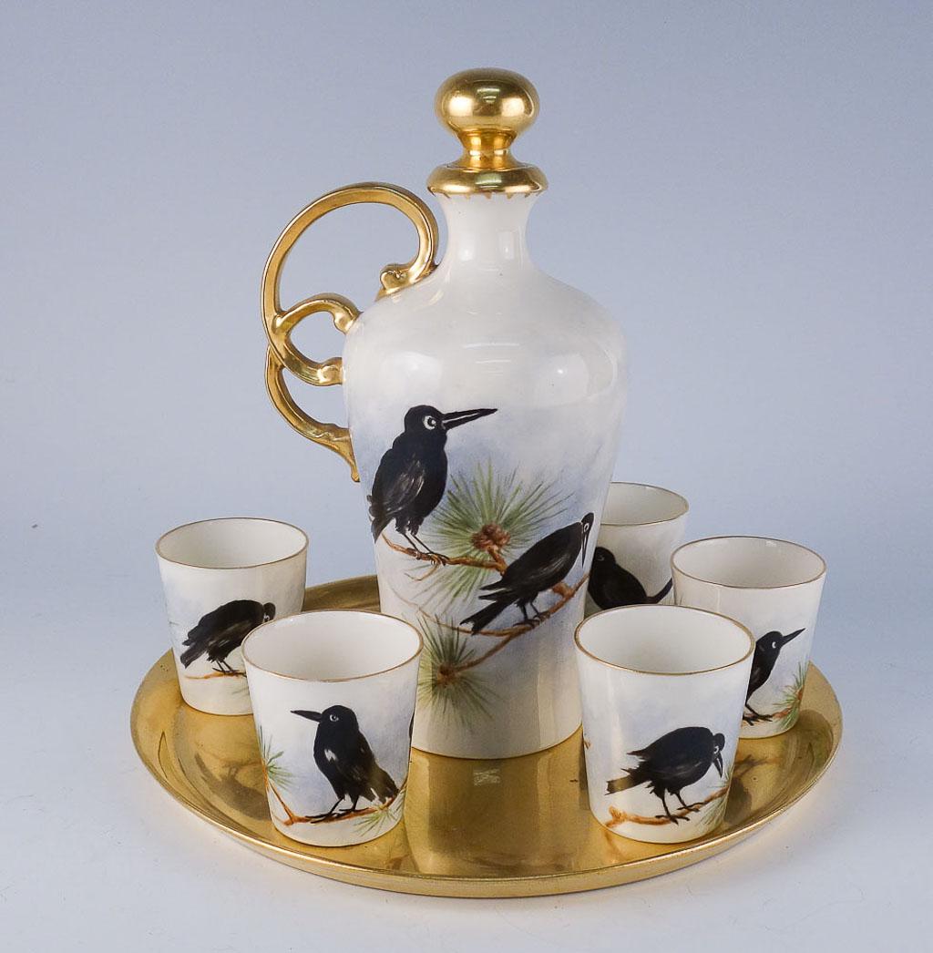 Willetts Belleek HP Raven Gilded Porcelain Decanter Set: Unusual estate found antique porcelain decanter and cordial set from Willets Belleek in the early 20th century. The decanter and cups are all hand painted with ravens and gilded details. The tray is f