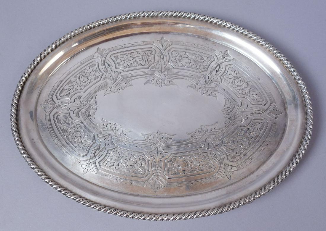 Tiffany Young & Ellis American Coin Silver Footed Tray: Ornate floral engraved footed American coin silver serving tray from Tiffany & Co under the leadership of JC Moore. Marked for Tiffany, Young, & Ellis of 550 Broadway. Numbered 199 and 1137. Free of m