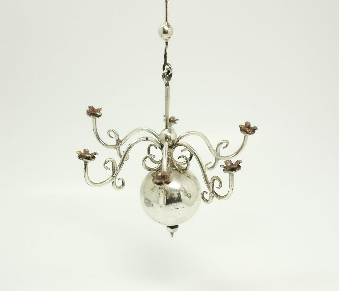 Dutch 833 Silver Mini Dollhouse Candelabra Chandelier: Estate found antique miniature dollhouse hanging chandelier dating to the early 20th century. Rendered in fine 835 silver, this chandelier features a globe finial with six scrolled candle holder arms.