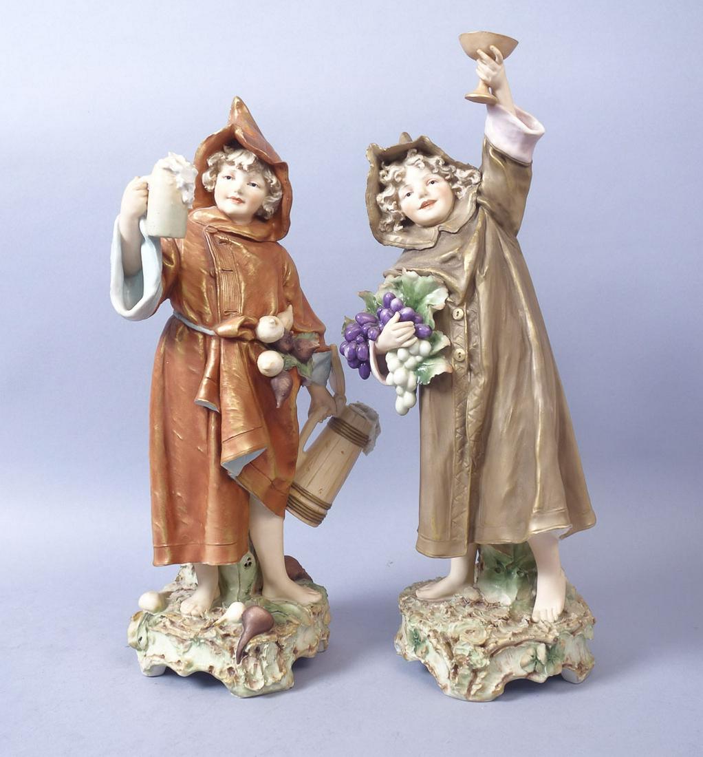 Pair Lg Royal Dux Porcelain Children as Monks Figurines: A pair of Royal Dux figurines depicting two young children in monks' robes toasting their harvest. Taller statue: 18 1/2" x 6 1/2" x 6" shorter statute 17 1/2" x 9" x 6"