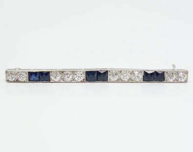 Art Deco Platinum Gold Diamond Sapphire Bar Pin Brooch: This is a stunning estate found Art Deco bar pin brooch dating to the 1920s. Rendered in fine platinum and gold, this pin is studded with Old European diamonds and sapphires. The diamonds are VS