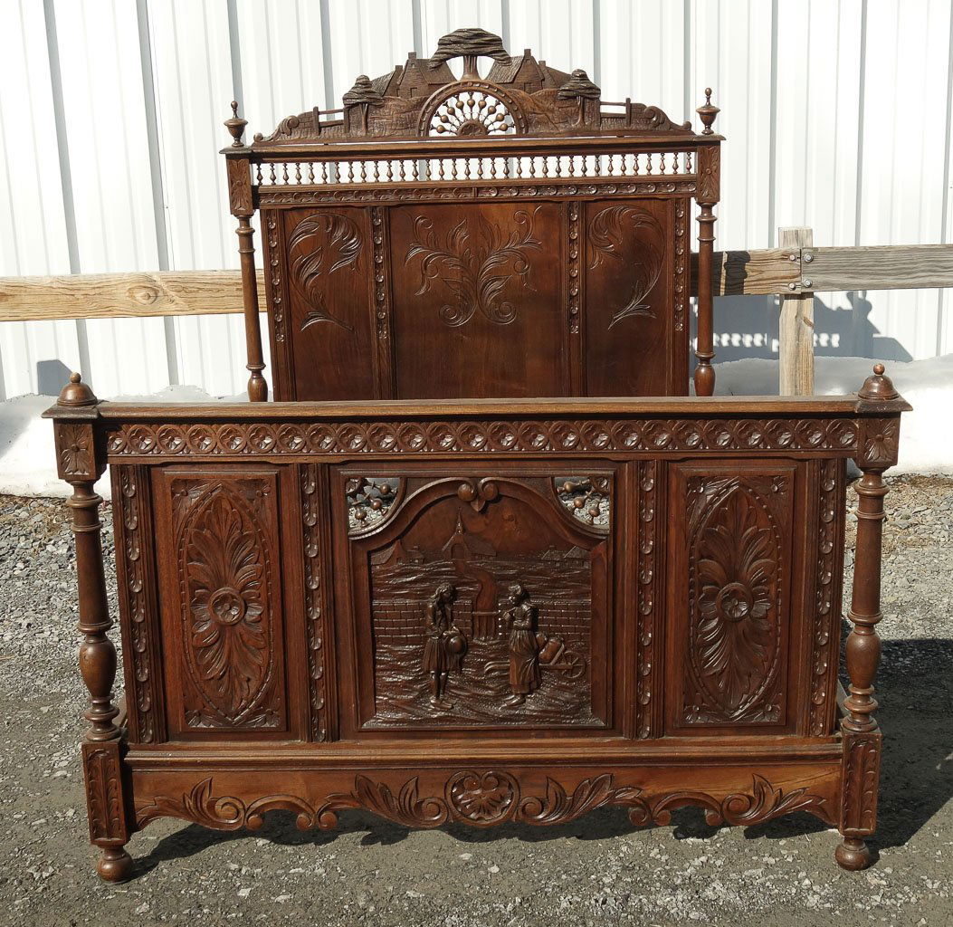 Antique Ornate Carved Landscape Scene Walnut Double Bed: This is an ornate antique carved walnut wooden double bed featuring a scene of a couple meeting in front of a chapel and a stunning landscape finial. The bed is comprised of 5 pieces: headboard, footb