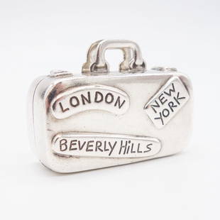 Tiffany Sterling Silver Luggage Suitcase Pill Box: This vintage Tiffany & Co. Philippines travel luggage suitcase pill box is rendered in .925 sterling silver. This suitcase is replete with travel destination labels. It measures 1 5/8 x 1 3/8 x 3/4"