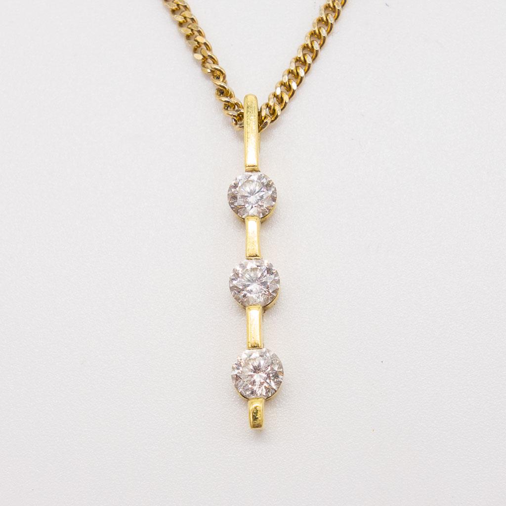14K Bar Set Three Stone Diamond Drop Pendant Necklace: This bar set three stone drop pendant necklace in 14K yellow gold features three round brilliant cut diamonds. This pendant is 1" long, has three round diamonds at approximately 0.75twt, and weighs 0.