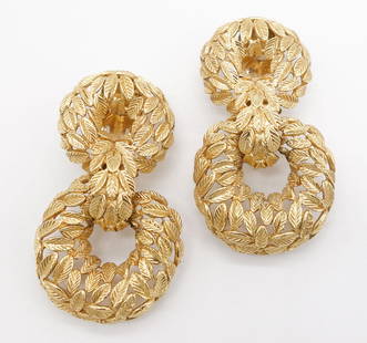 18K Double Drop Wreath Motif Clip Earrings: A pair of double drop clip earrings featuring two interconnected wreaths with leaf designs set in 18K yellow gold. These earrings measure 2" long, 1" wide, and weigh 23.4dwt.