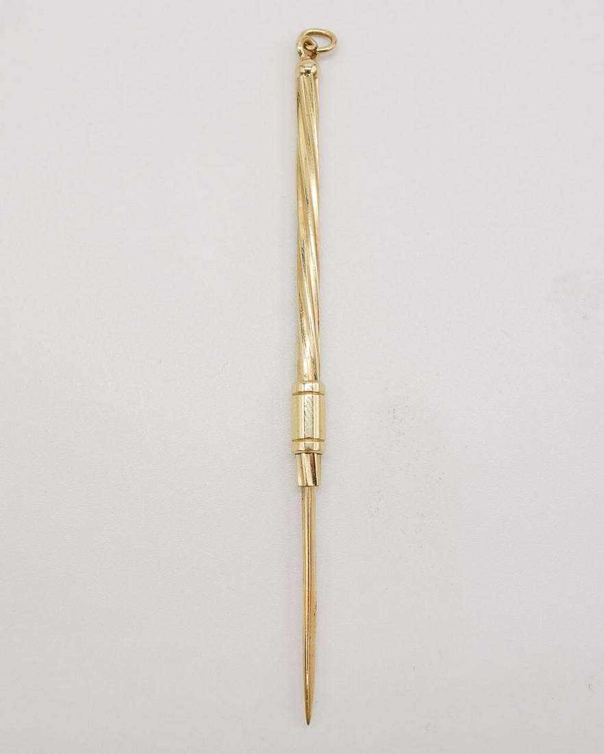 14K Gold Retractable Toothpick in Leather Case: This is a vintage retractable toothpick signed TIFANY. It is rendered in 14K gold and is set in a diminutive leather case. Fully open, it is 3 3/8" long. When retracted, it is 2 3/8" long. It weighs 2