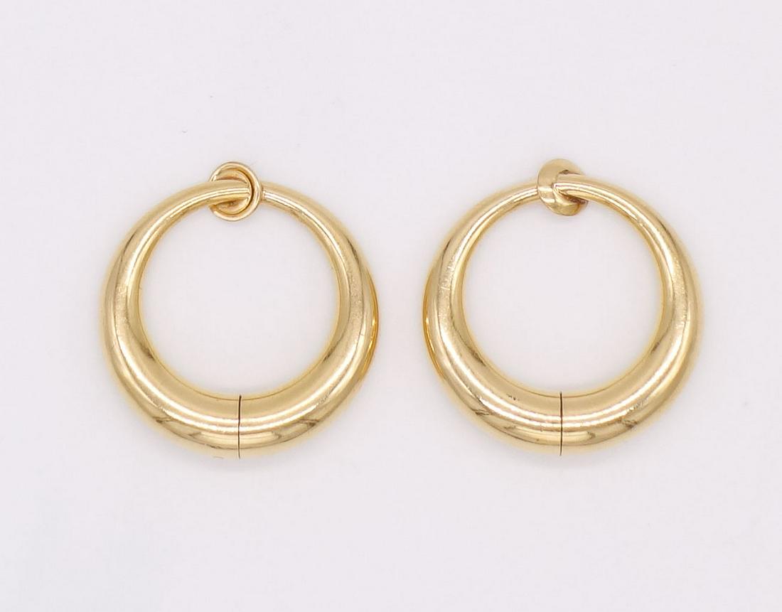 Pair 14K Gold Infinity Hoop Clip On Earrings: This is unusual pair of vintage infinity hoop earrings is rendered in 14K gold. These earrings are made to look as though they pierce the ear. Each is 7/8" diameter. The total weight of the pair is 4.