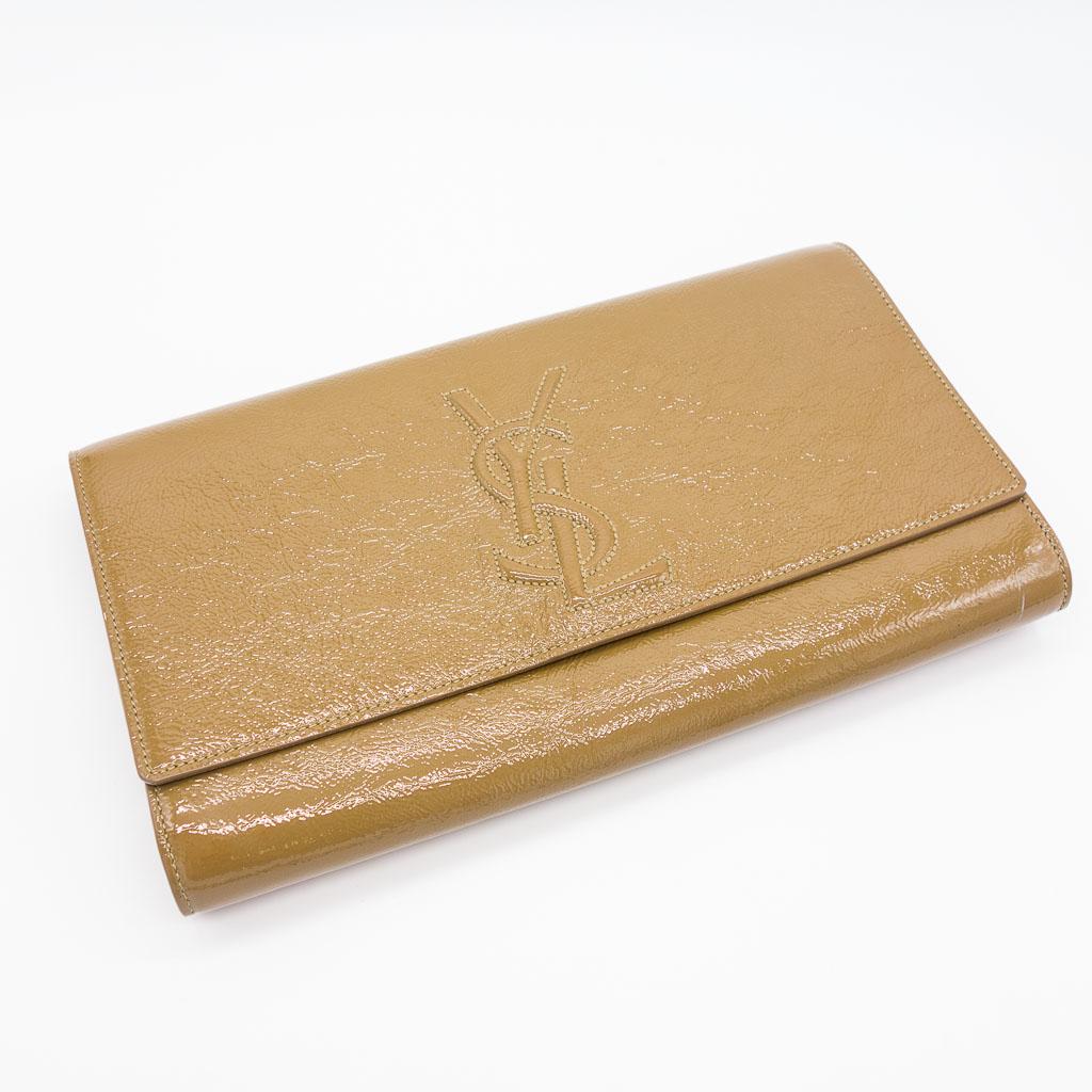 Yves Saint Laurent Large Belle De Jour Clutch: This Yves Saint Laurent Large Belle De Jour clutch bag is made in a khaki color patent leather with an olive green interior. It measures 11" x 6.25" x 1.5".