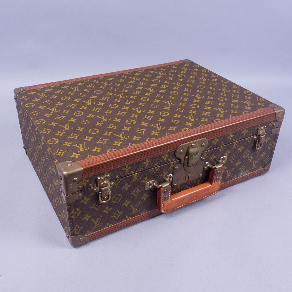 Louis Vuitton Cotteville 50 Hard Side Suitcase: This vintage Louis Vuitton Cotteville 50 hardside suitcase features the classic brown monogram canvas, leather trim, and brass findings with a lock. It measures 19 3/4" x 14 1/2" x 6 3/4".