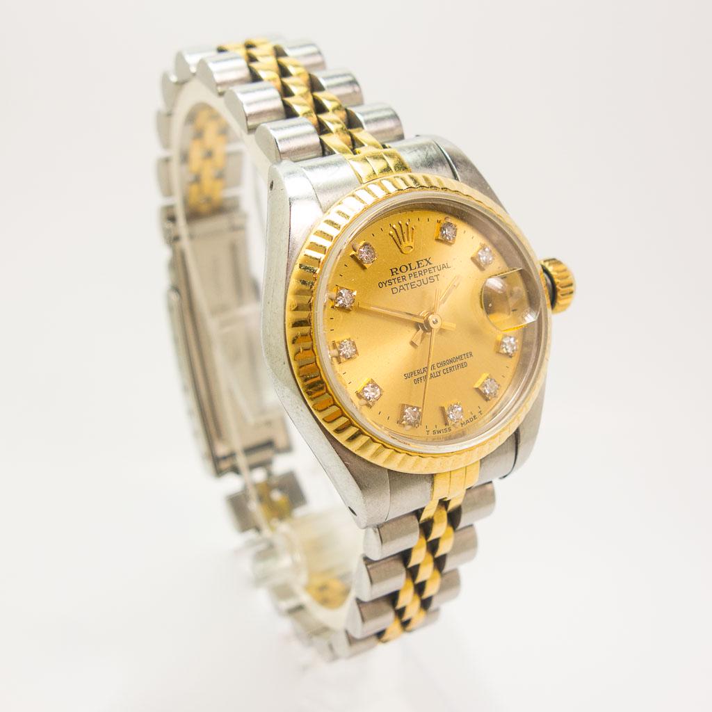 Rolex 26mm DateJust 18K Stainless Steel Diamond Watch: This automatic Rolex 26mm DateJust watch circa 1989 is made in stainless steel and 18K yellow gold. It features a Jubilee bracelet, fluted bezel, and champagne diamond dial. Reference # 69173, serial 