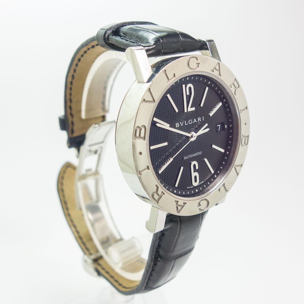 Bvlgari BB 38 SL Stainless Steel Automatic Wristwatch: This 38mm stainless steel Bvlgari BB 38 SL automatic wristwatch features a black arabic dial and a black leather strap with a deployment buckle. This watch is 38mm and the serial number is L 4629.