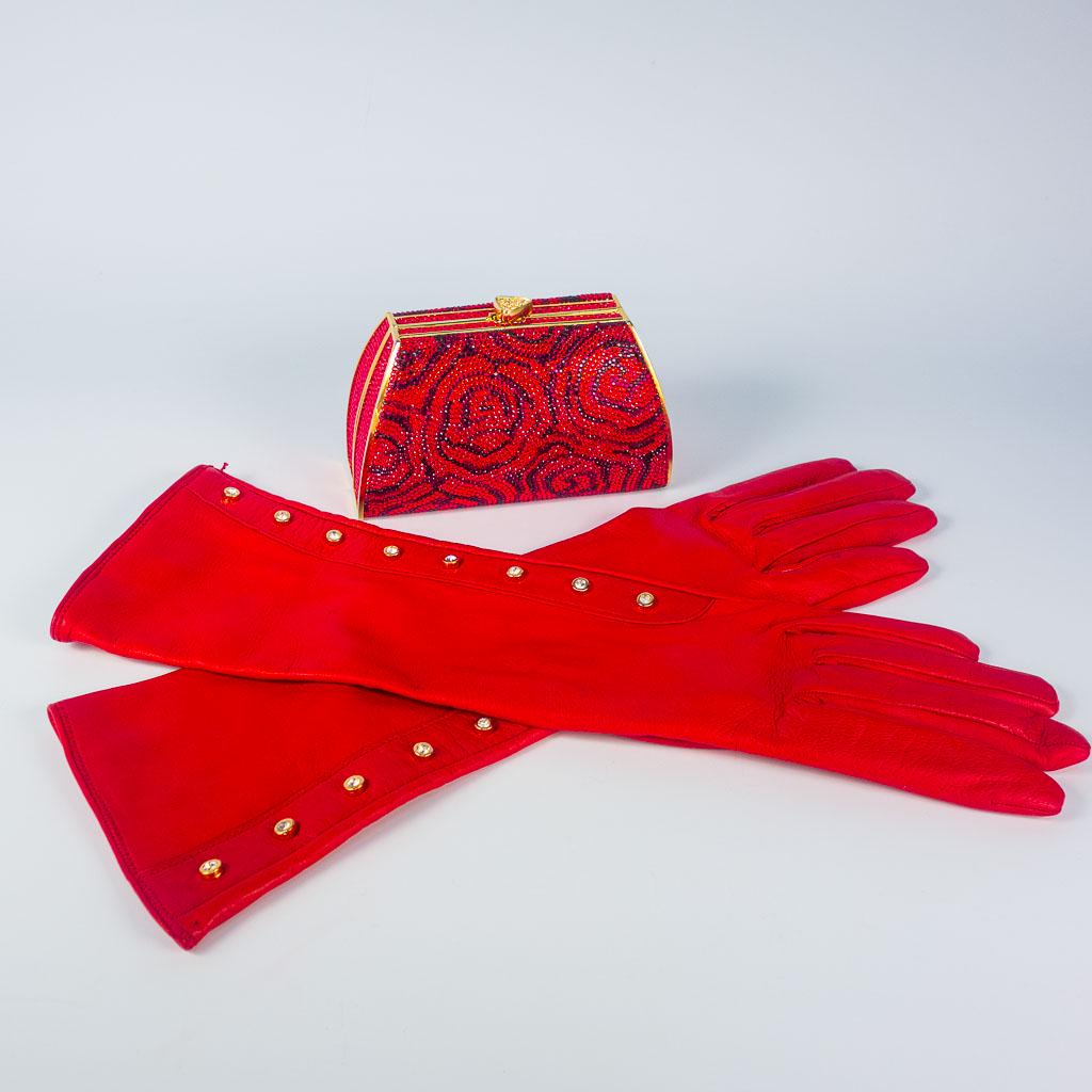Judith Leiber Evening Clutch Bag & Red Calfskin Gloves: This hard case evening clutch by Judith Leiber feature gold colored hardware with a chain strap and a gold colored coin purse. This bag is adorned with a red and black jeweled rose pattern. These long