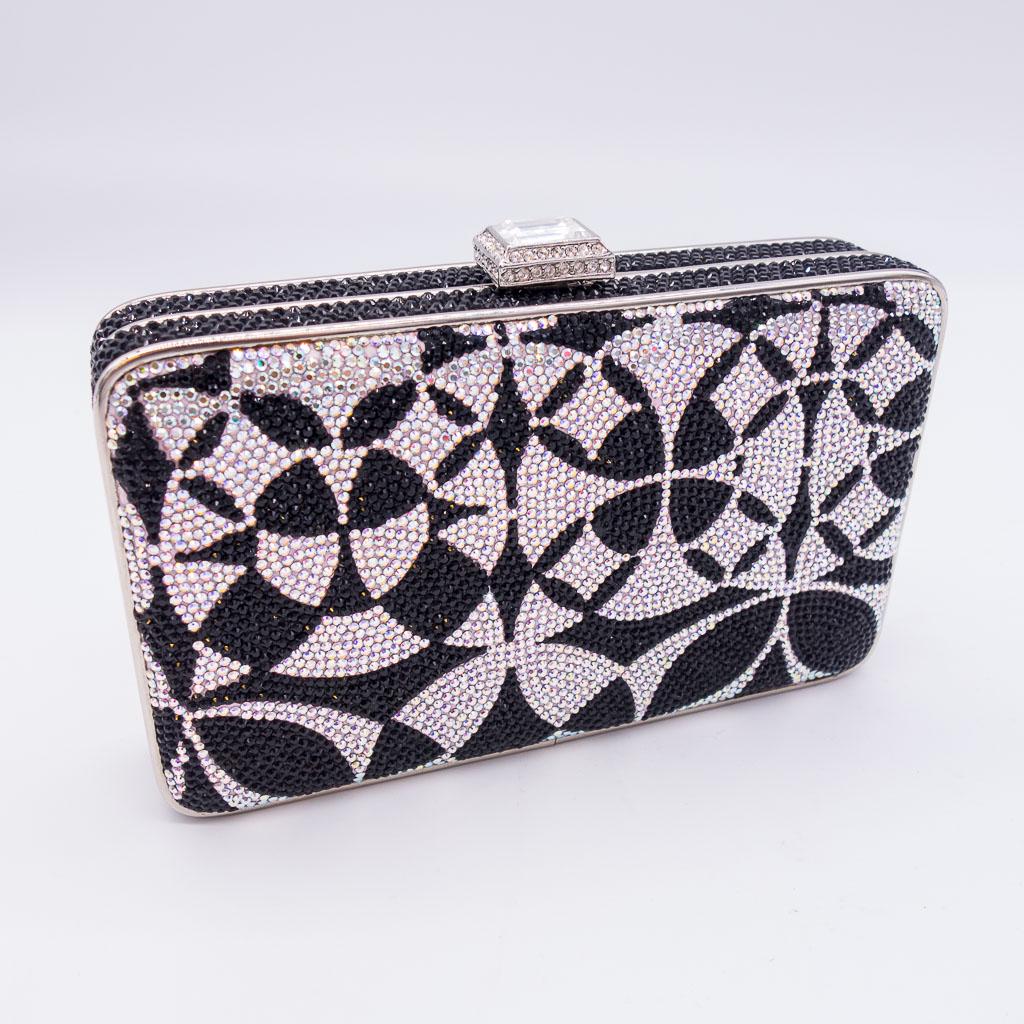 Judith Leiber Jeweled Rectangular Evening Clutch Bag: This rectangular hard case evening clutch by Judith Leiber features a silver colored chain and pocket-sized mirror. The exterior is adorned with black and white jeweled pattern and a jeweled button. T