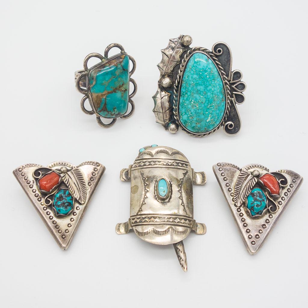 Native American Sterling Silver Rings, Pin, Belt Tips: This is a set of Native American crafted jewelry and accessories. Each is rendered in sterling silver and decorated with coral and/or turquoise. The lot includes a pair of belt tips, two rings, and an