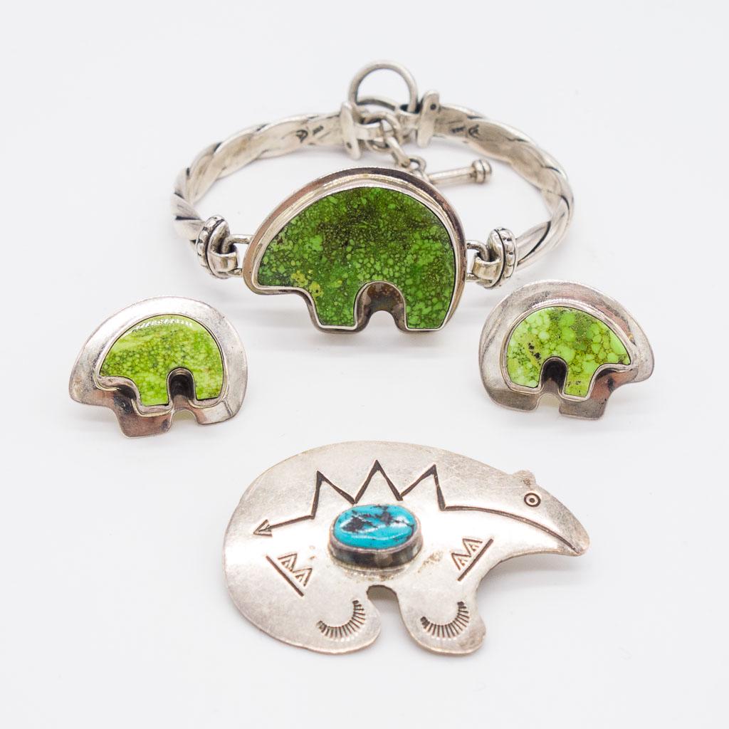 Native American Sterling Silver Turquoise Bear Jewelry: This is a lot of Native American jewelry with bear motifs accented with turquoise. Rendered in sterling silver, this lot includes a pair of earrings signed "LB", brooch/pendant signed "RS", and a brac