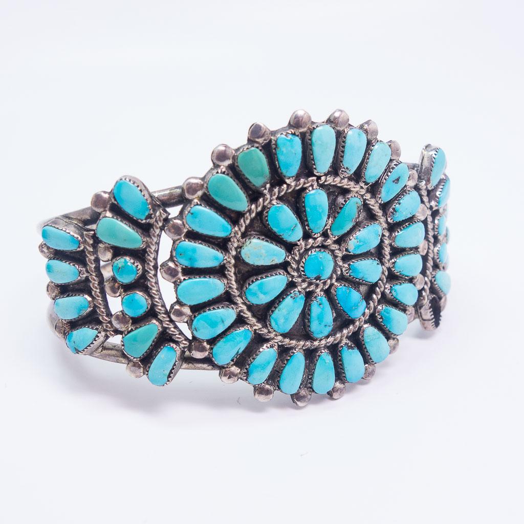 Native American Pawn Sterling Silver Turquoise Bracelet: This is an antique American Indian pawn cuff bracelet. Rendered in sterling silver, this Zuni cuff features a turquoise petit point design. The interior length of the cuff is 5 3/8" plus a gap of 1" a
