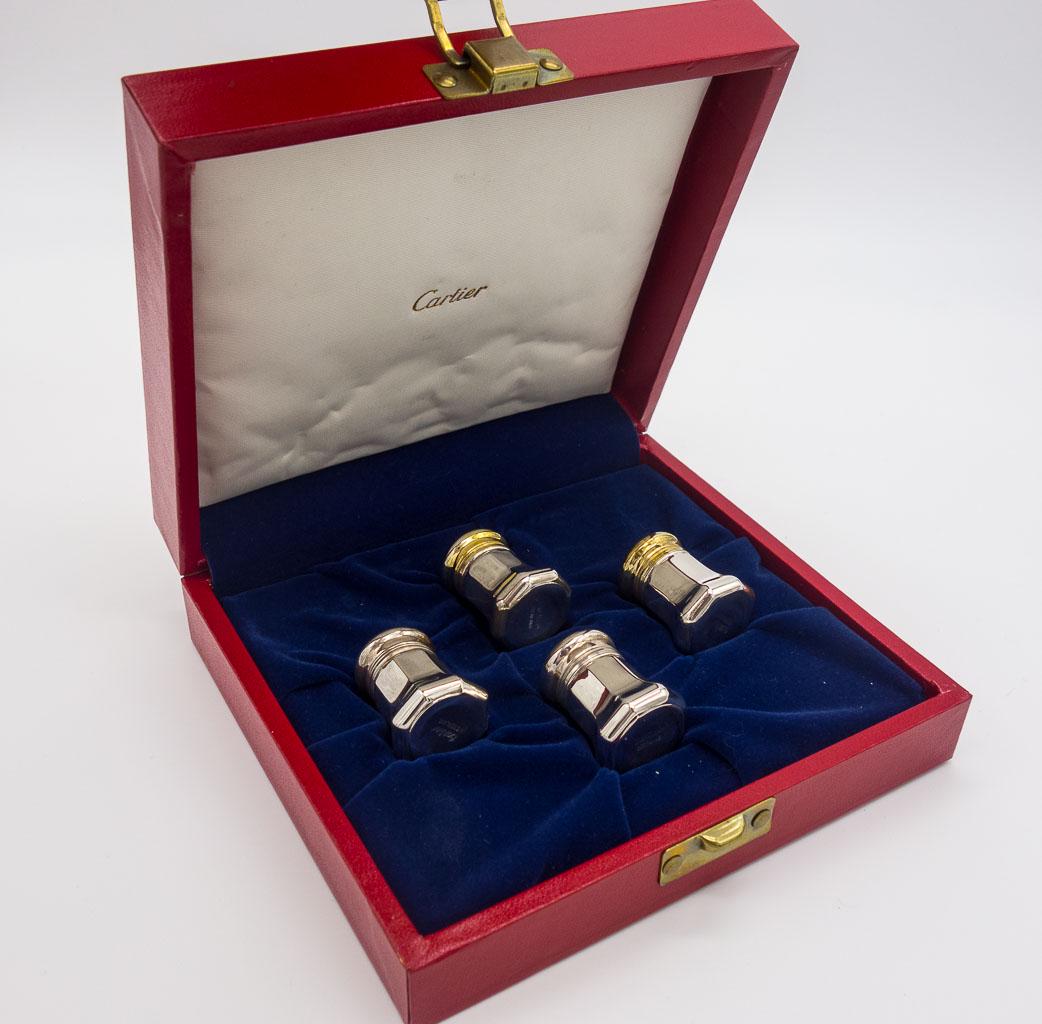 Cartier Cased Set Sterling Silver Salt & Pepper Set: This is a Cartier cased salt and pepper set. Rendered in sterling silver, the diminutive set of four, features gilt tops on the pepper shakers. Set in a fitted Cartier case. Each shaker is 1 3/8" tall