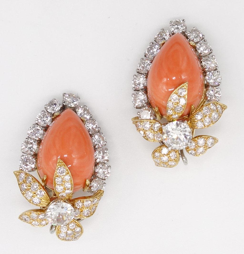 David Webb 18K Angel Skin Coral Diamond Clip Earrings: These David Wedd floral clip on earrings in 18K gold feature angel skin coral and round brilliant diamonds. The center pear-shaped cabochon coral is surrounded by a halo of diamonds. At the base of th