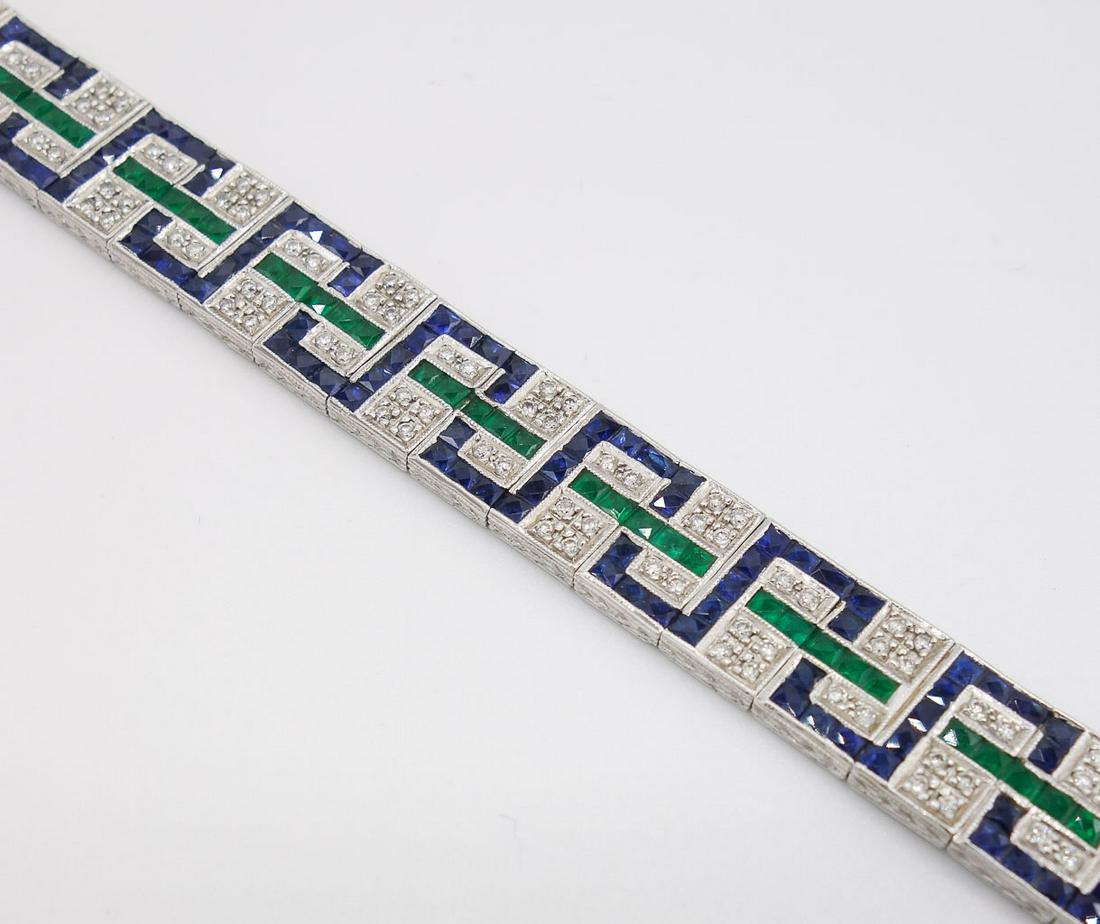 Art Deco Sophia D Diamond Sapphire Emerald Bracelet: This Art Deco style platinum line bracelet by Sophia D features natural sapphires, emeralds, and diamonds with hand engraving along the edges. This bracelet is 7" long and weighs 17.13dwt. There are a