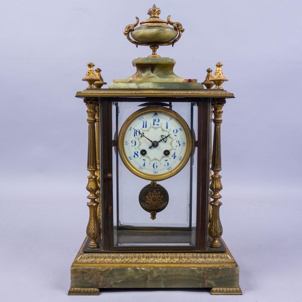 Antique Japy Freres Bronze Dore Onyx French Clock: This antique Japy Freres bronze dore green onyx clock is encased in a rectangular glass.The clock features a white Arabic dial, a pendulum, and is topped with a bronze and green onyx finial. The Clock