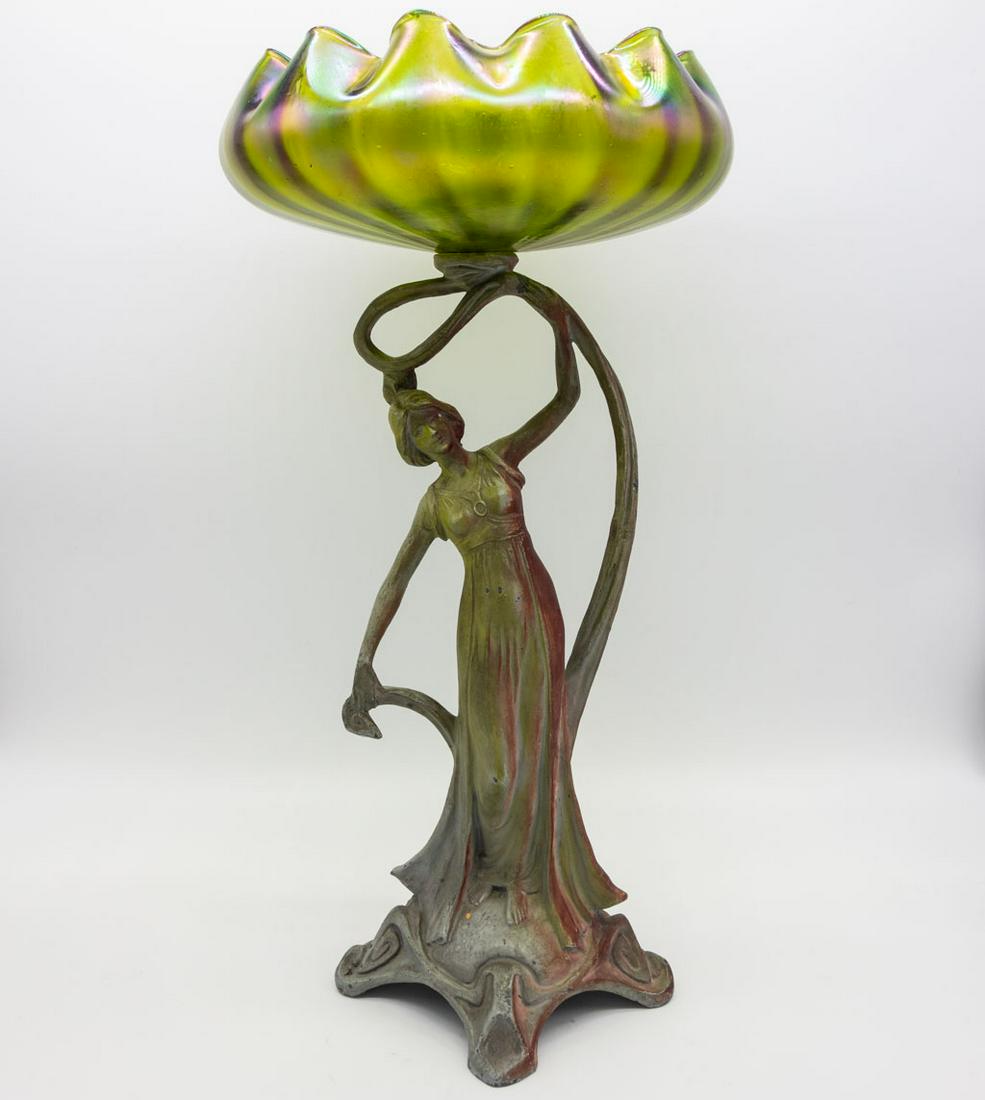 Antique Art Nouveau Figural Art Glass Compote: This is an antique Art Nouveau figural compote dating to around the turn of the century. The base features a beautiful maiden (in white metal) whom holds aloft the green iridescent floraform art glass