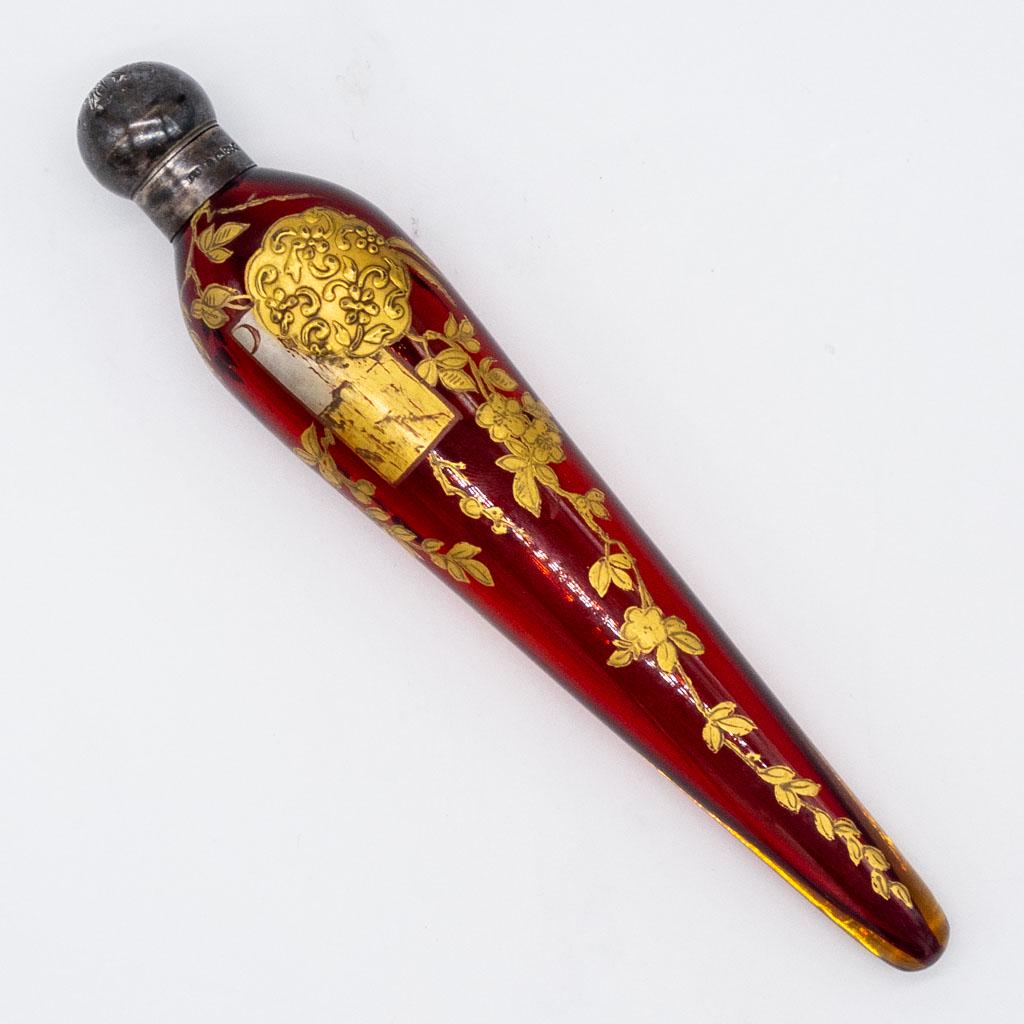 Antique Victorian Gilt Ruby Glass Silver Perfume Vial: This is an antique 19th century Victorian perfume vial in hand- painted ruby glass with a floral motif and a rounded sterling silver lid. 8 x1 5/8th". Stamped with Passant Lion.