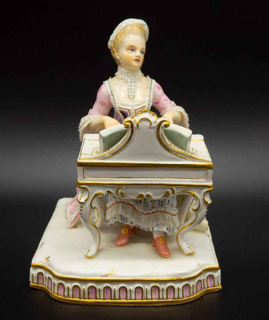 Antique Meissen Figurine of Lady Playing Harpsichord: A meissen figurine depicting a continental lady playing the harpsichord. Marked with the Meissen blue crossed swords. 5 x 3.75 x 3.25"