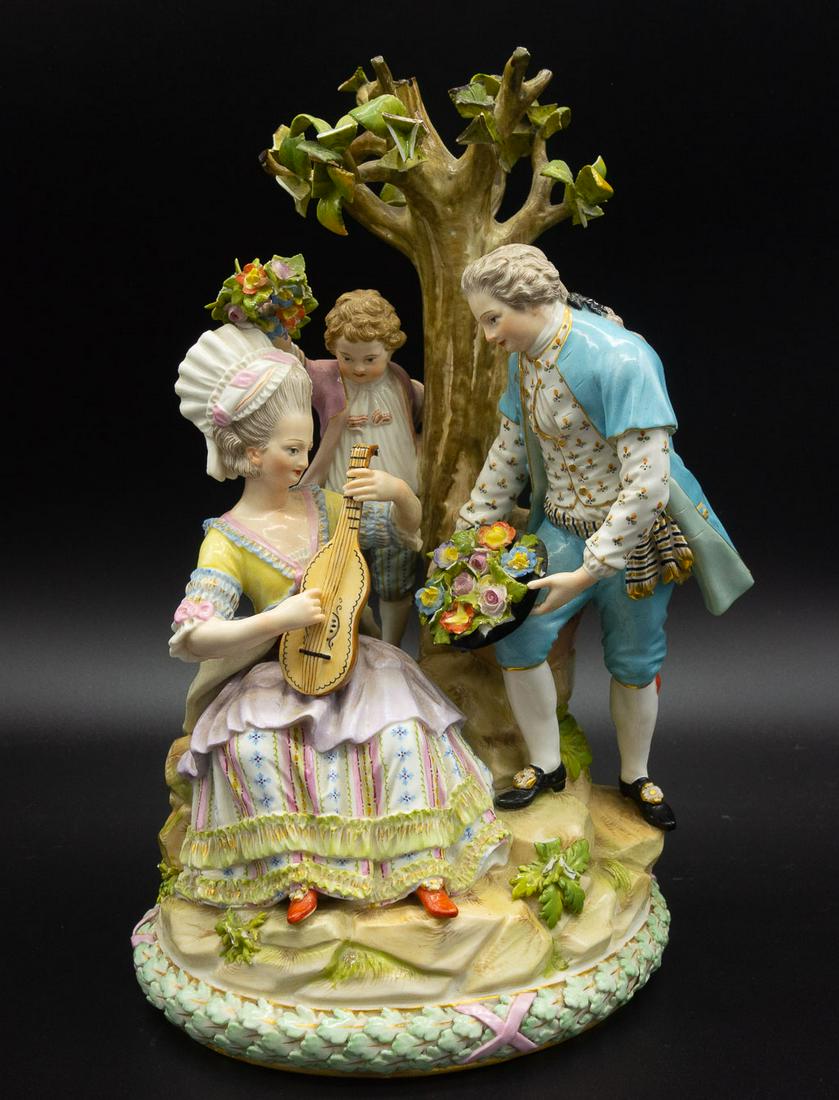 3 Antique Meissen Porcelain Figures: This antique meissan porcelain figural group features three characters under a tree. There is a woman playing the lute, a man offering the woman flowers in a hat, and a little boy trying to place a fl