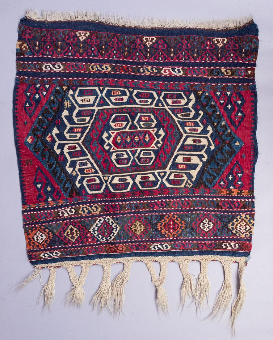 Early 20c Persian Flatweave Bagface Rug: This is a Persian flatweave bagface rug circa early 20th century. It features a multicolor geometric design with fringed ends. 35 x27"