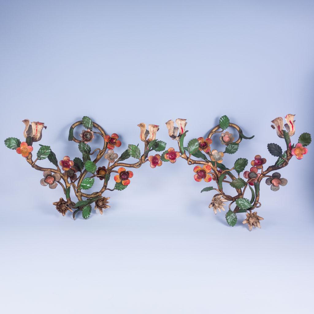 Antique Italian Polychrome Painted Iron Candle Sconces: A pair of antique iron Italian candle sconces. They features a hand painted floral motif with two tulip shapes on each that hold candles. 10" Length