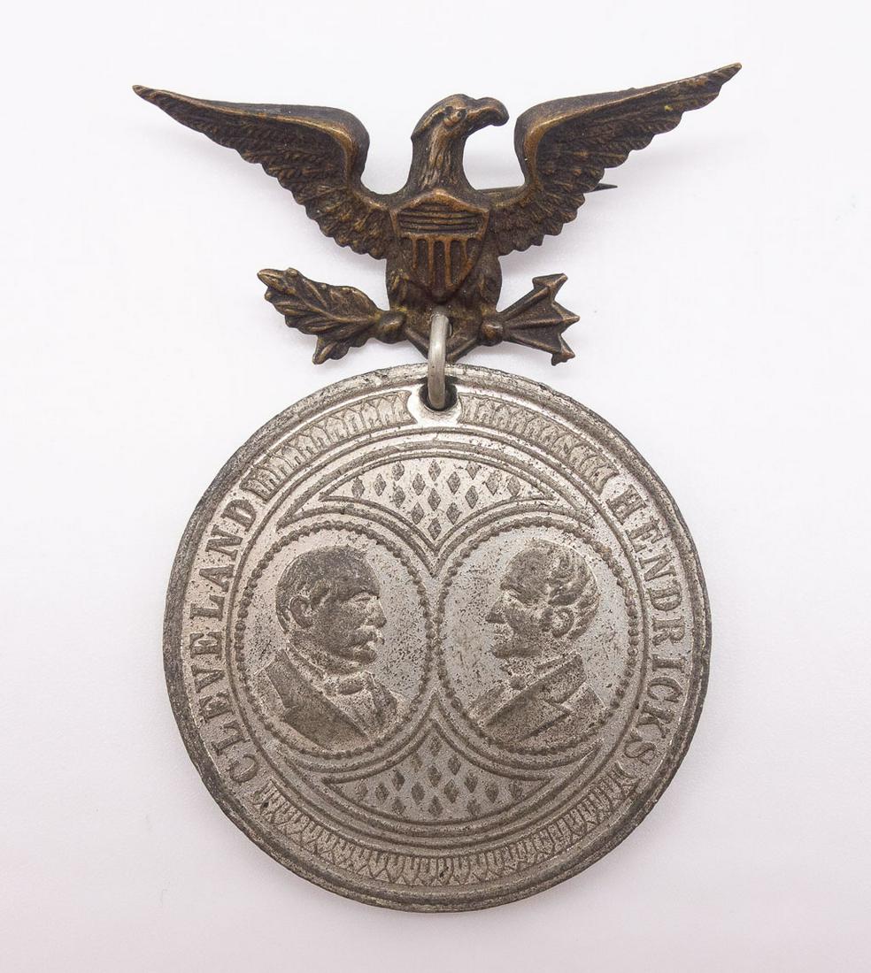 President Cleveland Hendricks Jugate Inauguration Medal: This jugate celebrates the inauguration of former President Grover Cleveland and former Vice President Thomas Hendricks on March 4, 1885. The back of the medal features an eagle holding a shield and f