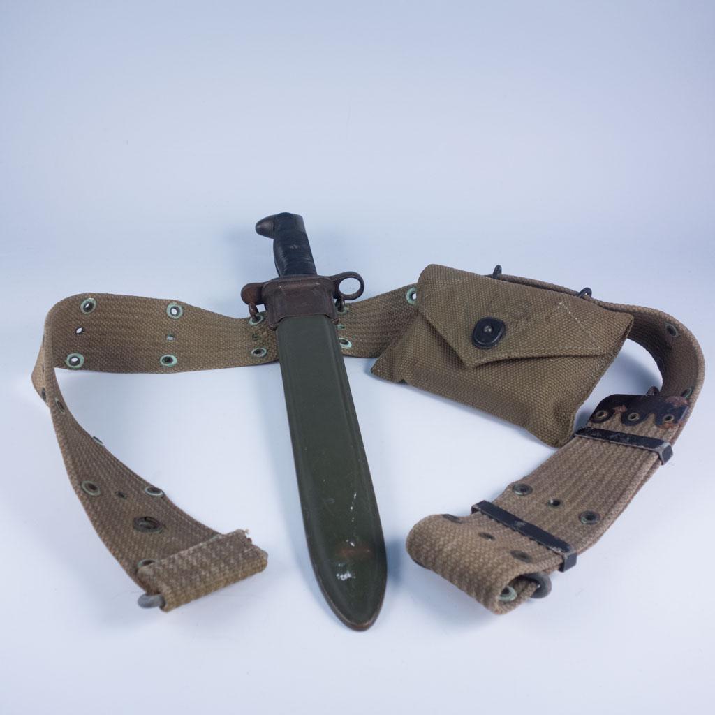 WWII 1942 M1 Garand Bayonet, First Aid Kit and Belt: WWII gear belt including a United States military M1 Garand bayonet with sheath and sealed first aid kit. The bayonet is dated to 1942. Belt: Approx 37 1/2", Bayonet Overall: 14 1/2", Blade: 9 7/8", R