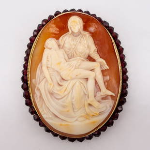 Cameo Brooch of Pieta by Michelangelo Gold and Garnet: This cameo brooch pendant is set in 14K yellow with a border of red garnet beads. This cameo depicts Michelangelo's Pieta statue. Measures 3" x 2.25". Weighs 21.4dwt.