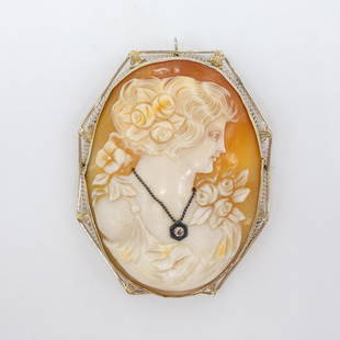 14K White Gold Filigree Diamond Lg Cameo Pendant Brooch: This is a large antique carved cameo pendant/brooch featuring a cameo of an elegant woman with an old european cut diamond necklace. Framed by an ornate filigree 14K white gold setting. 10K yellow