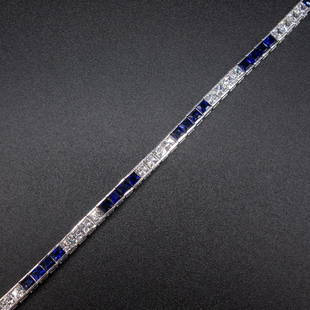 White Gold Line Bracelet with Synthetic Sapphire and CZ: This bar set white gold line bracelet is stamped 14K and tests as 14K white gold. It features princess cut clear cubic zirconias and synthetic blue sapphires. 7" long, 3.7mm wide, 28 CZs at 2.7mm, 28